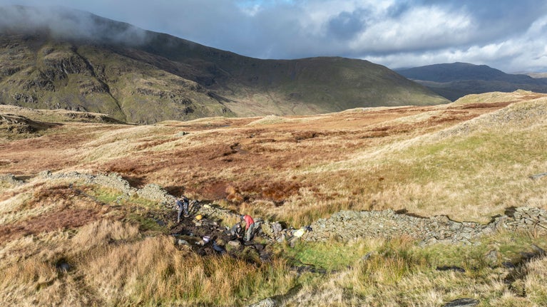 Aerial view of rangers restoring the path with the help of volunteers as part of the Fix the Fells project at Ravens Edge, Kirkstone Pass, Cumbria